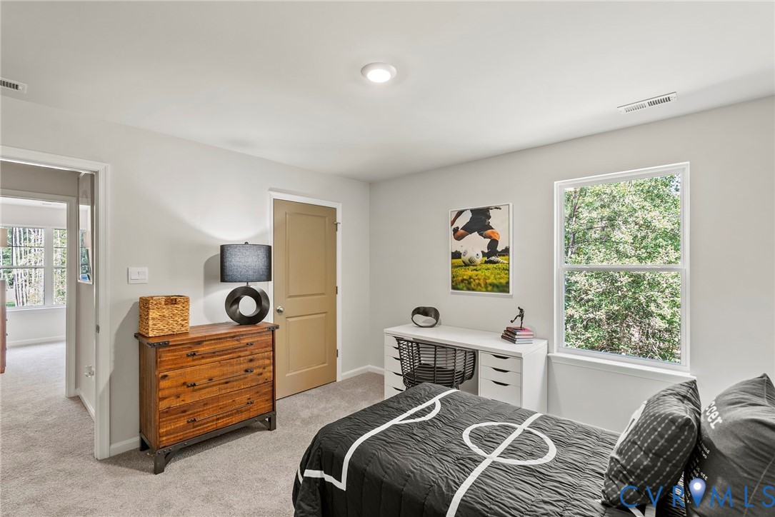 7745 Arbor Marsh Terrace New Kent, VA 23124 - Photo 19 of 30 a bedroom with a bed and a window