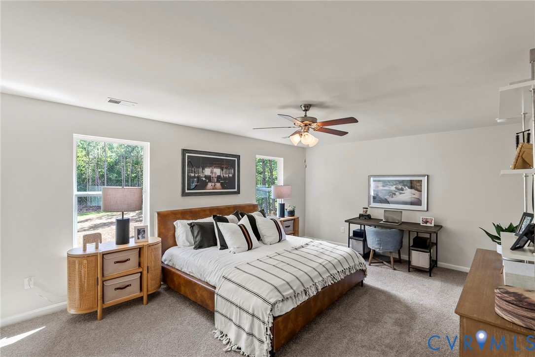7745 Arbor Marsh Terrace New Kent, VA 23124 - Photo 20 of 30 a spacious bedroom with a bed and wooden floor