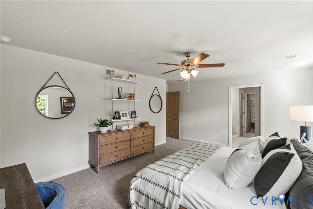 7745 Arbor Marsh Terrace New Kent, VA 23124 - Photo 21 of 30 a bedroom with a bed and a chandelier