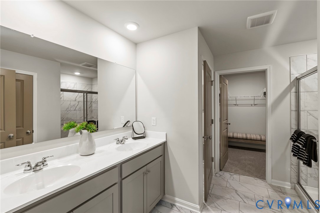 7745 Arbor Marsh Terrace New Kent, VA 23124 - Photo 22 of 30 a bathroom with a double vanity sink and a mirror