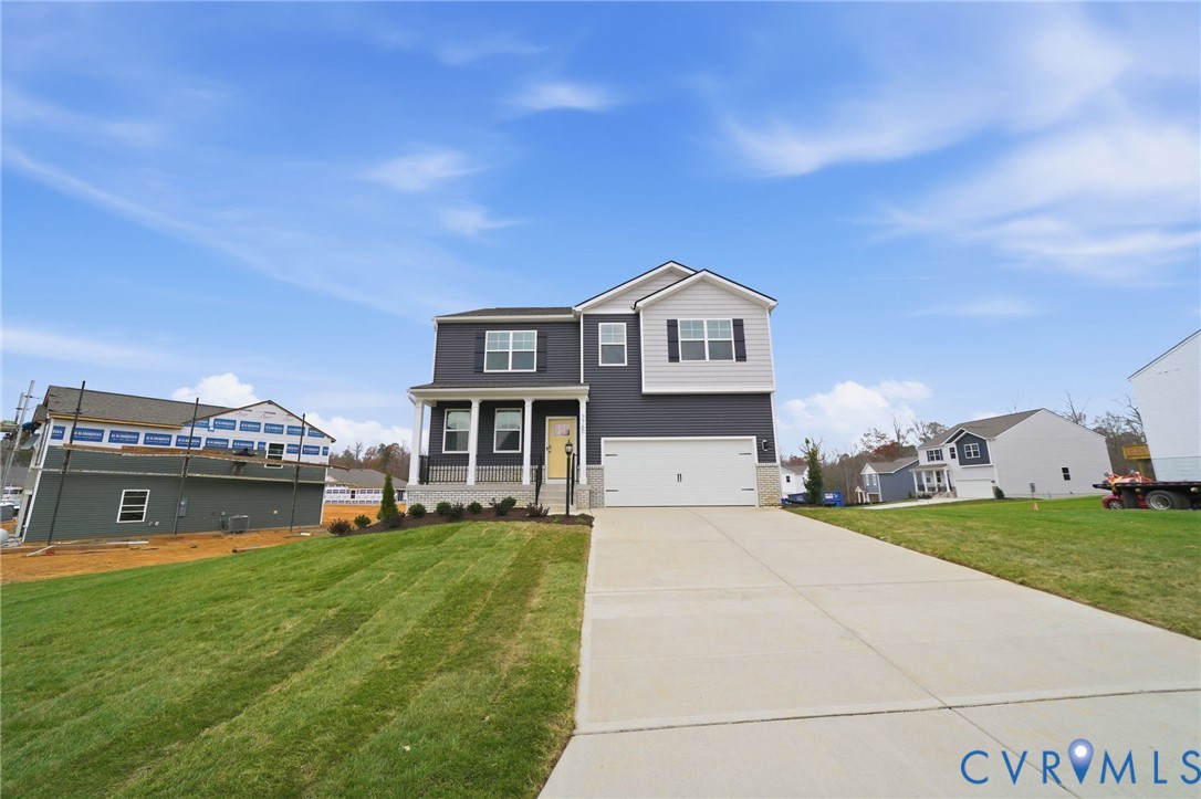 7745 Arbor Marsh Terrace New Kent, VA 23124 - Photo 25 of 30 a front view of a house with a garden and yard