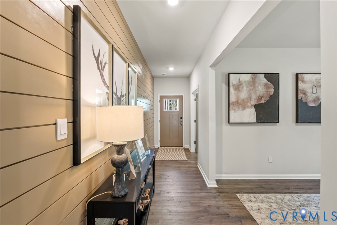 7745 Arbor Marsh Terrace New Kent, VA 23124 - Photo 8 of 30 a view of a hallway with wooden floor and furniture