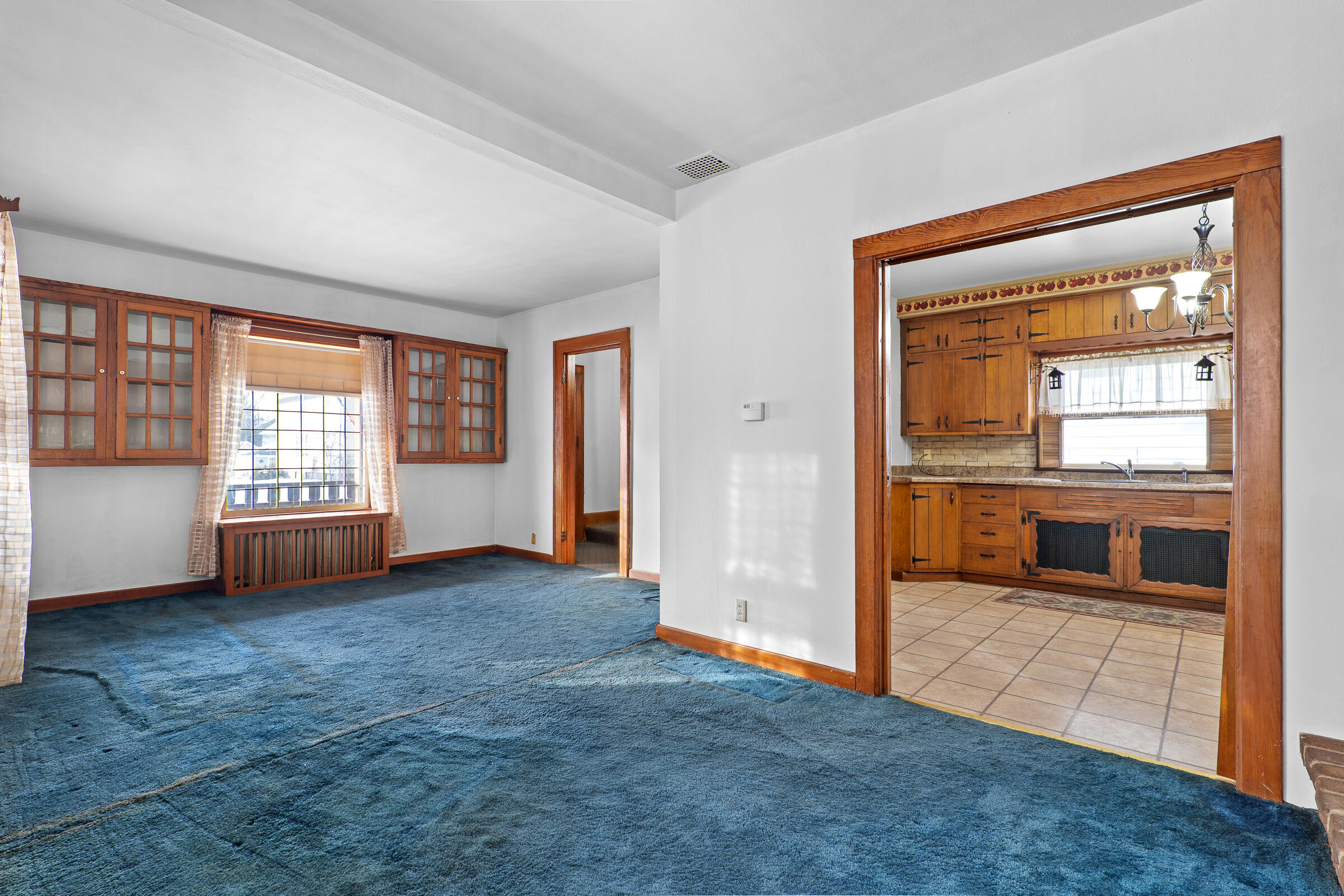 851 North 10th Street Manitowoc, WI 54220 - Photo 7 of 39 Presenting a pocket door into the kitchen and added built-ins.