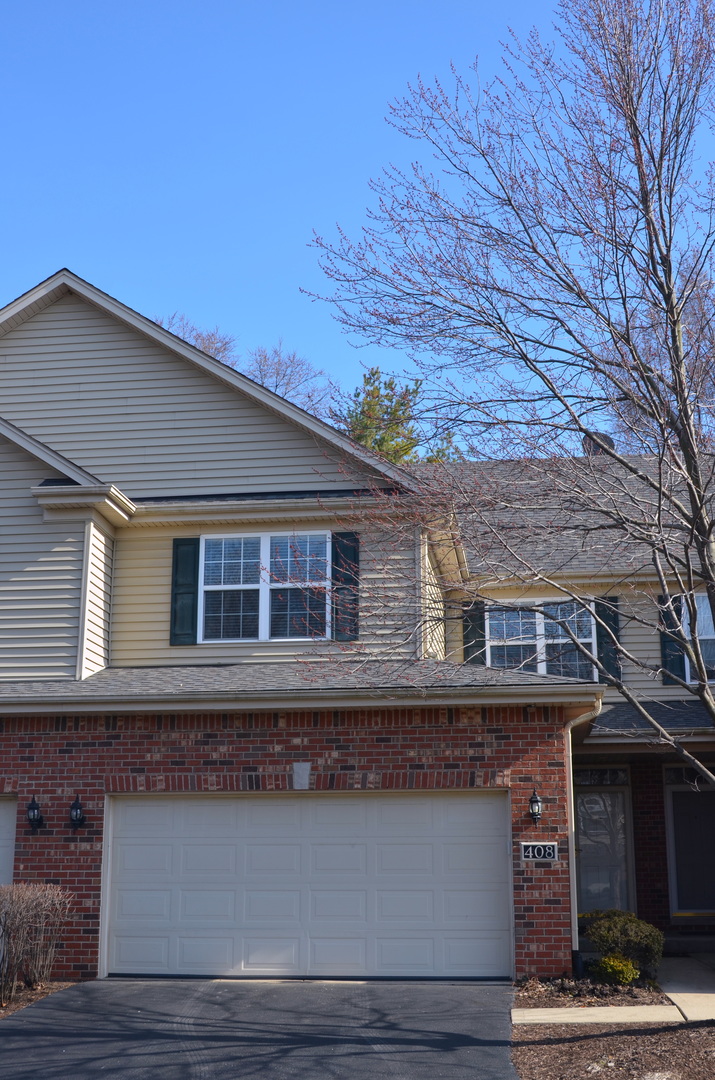 408 North River Road, Unit 408 Naperville, IL 60540 - Photo 2 of 36 a front view of a house with a garage