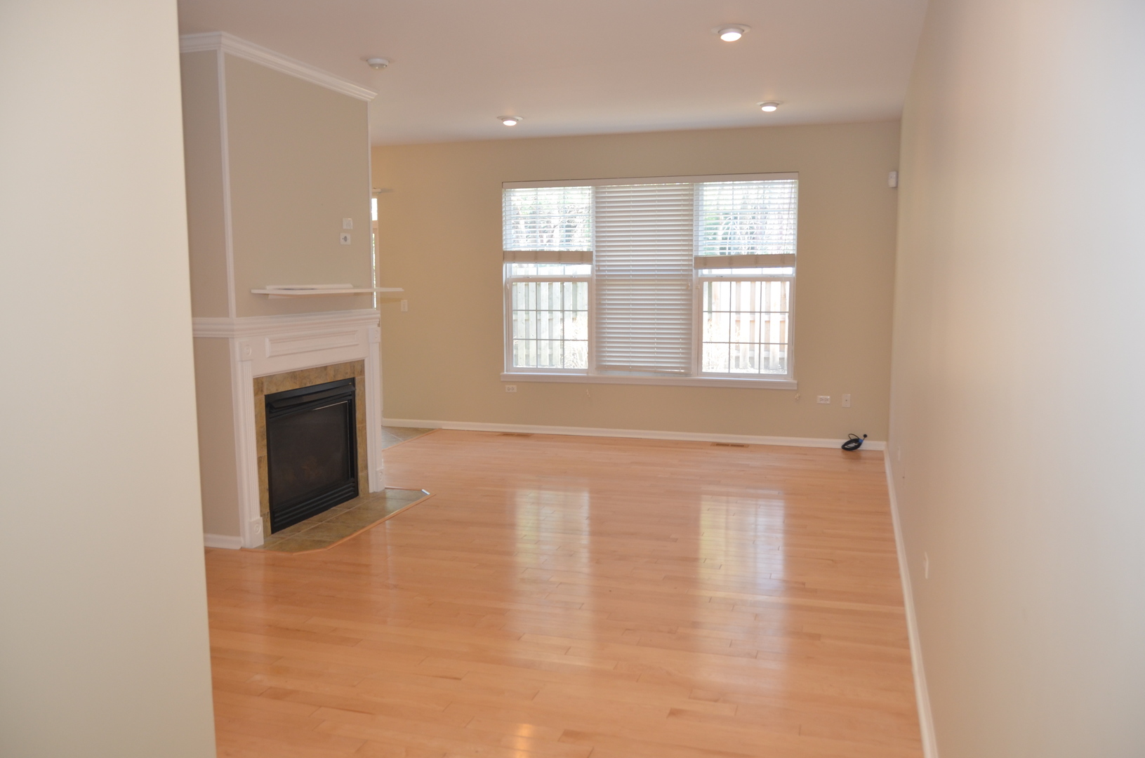 408 North River Road, Unit 408 Naperville, IL 60540 - Photo 11 of 36 a view of an empty room with a window and a kitchen