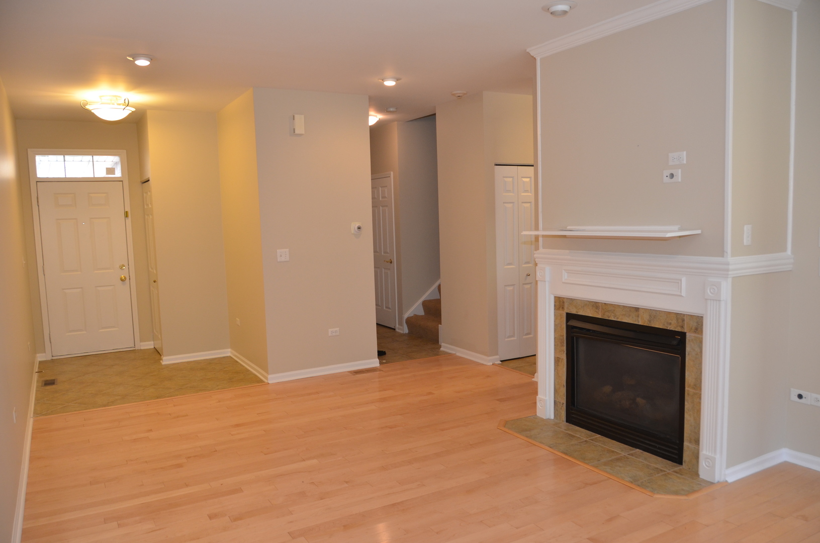 408 North River Road, Unit 408 Naperville, IL 60540 - Photo 12 of 36 a view of an empty room with a fireplace