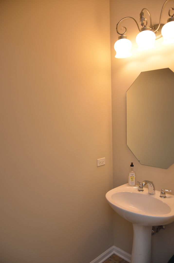 408 North River Road, Unit 408 Naperville, IL 60540 - Photo 14 of 36 a bathroom with a sink and a mirror