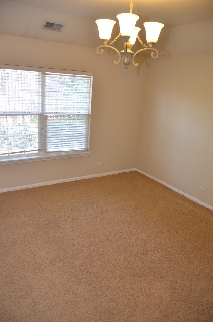 408 North River Road, Unit 408 Naperville, IL 60540 - Photo 18 of 36 an empty room with a window
