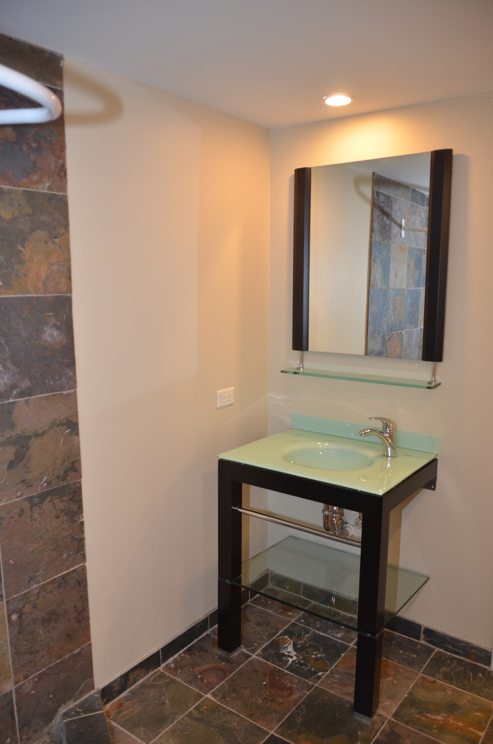 408 North River Road, Unit 408 Naperville, IL 60540 - Photo 33 of 36 a bathroom with a sink and a mirror