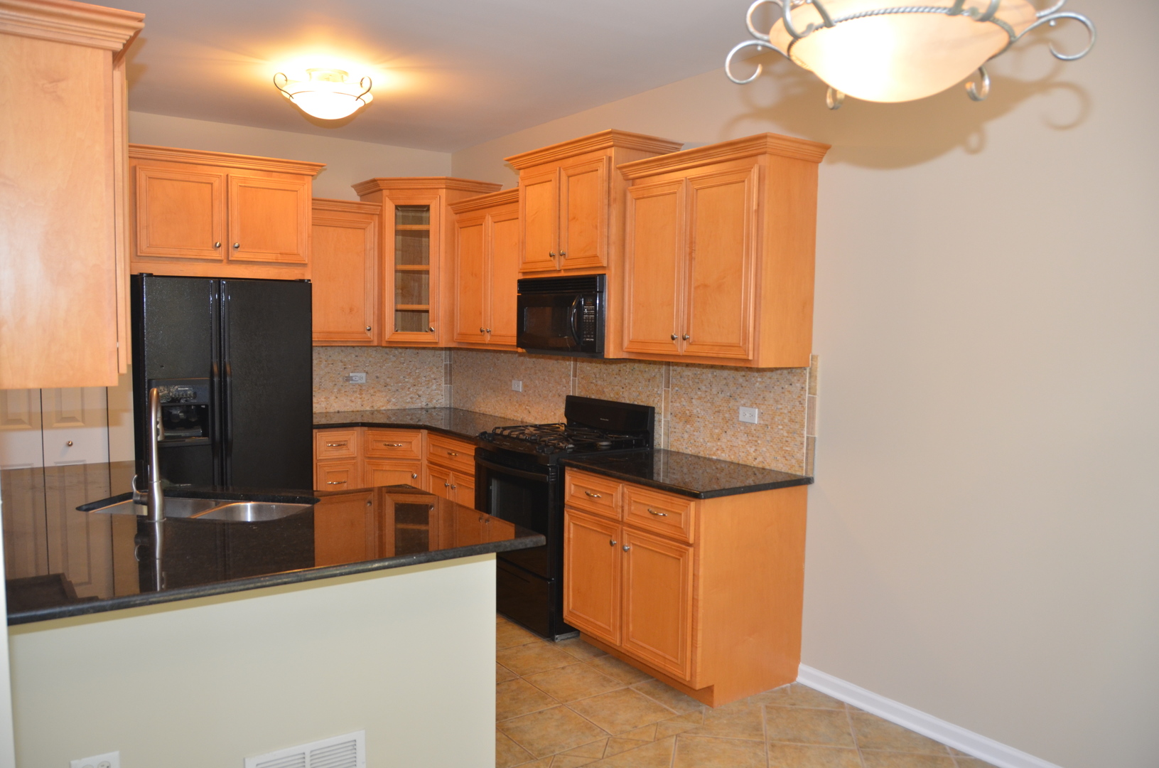 408 North River Road, Unit 408 Naperville, IL 60540 - Photo 5 of 36 a kitchen with stainless steel appliances granite countertop a refrigerator a stove and a sink with wooden cabinets