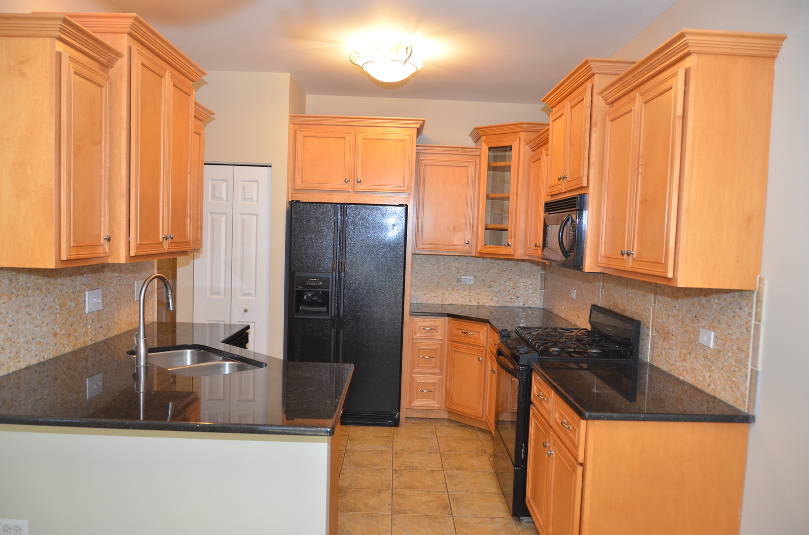 408 North River Road, Unit 408 Naperville, IL 60540 - Photo 6 of 36 a kitchen with stainless steel appliances granite countertop a refrigerator a stove and a sink with wooden cabinets