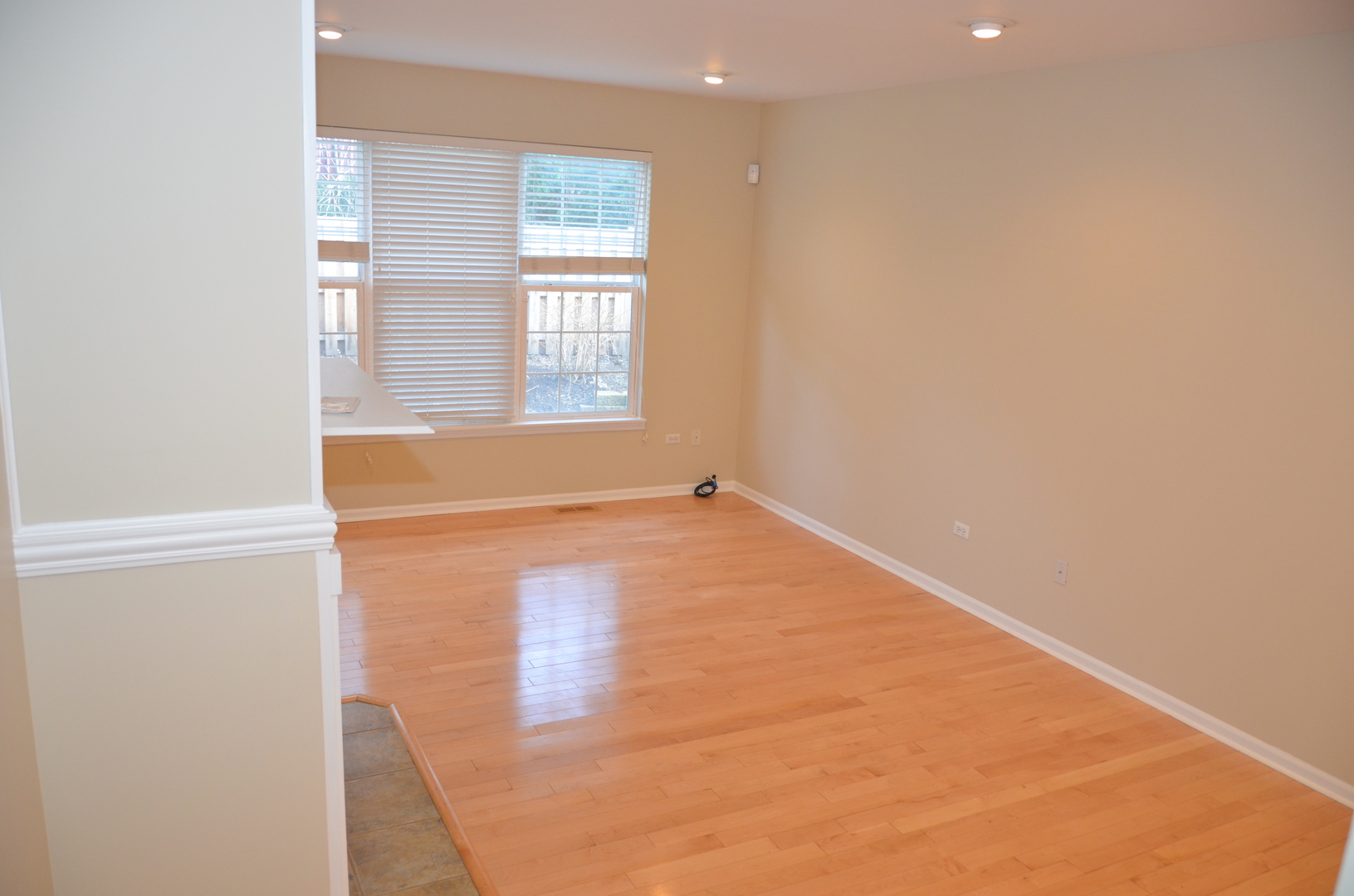 408 North River Road, Unit 408 Naperville, IL 60540 - Photo 10 of 36 an empty room with wooden floor and windows