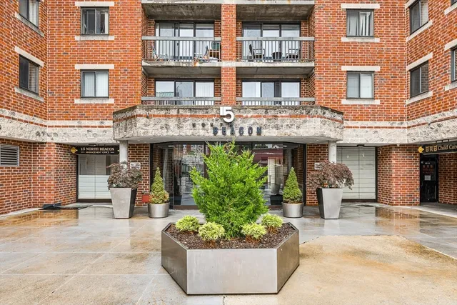 a front view of a building with potted plants