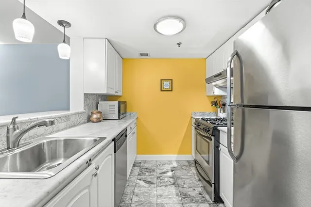 a kitchen that has a sink and a refrigerator