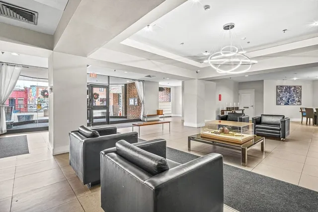 a living room with furniture and a chandelier