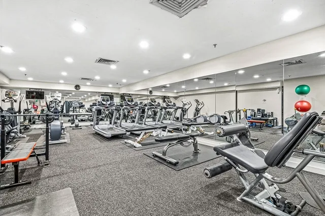 a view of a room with gym equipment and lots of equipment