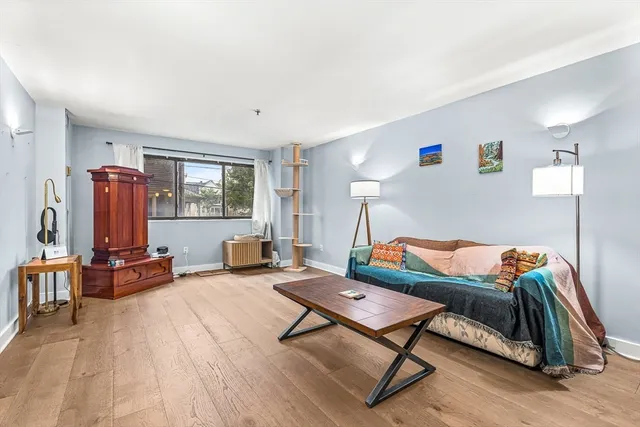 a outdoor living room with furniture and a flat screen tv