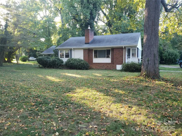a front view of a house with yard and green space