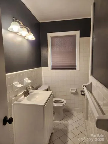 a bathroom with a sink mirror and toilet