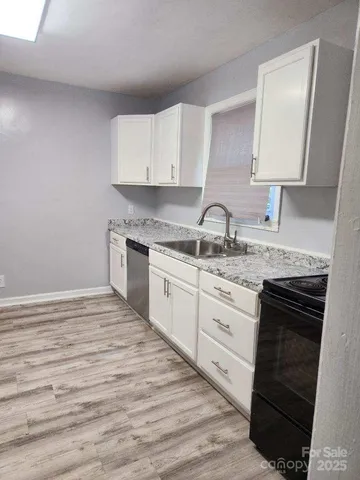 a kitchen with stainless steel appliances granite countertop a sink stove and cabinets