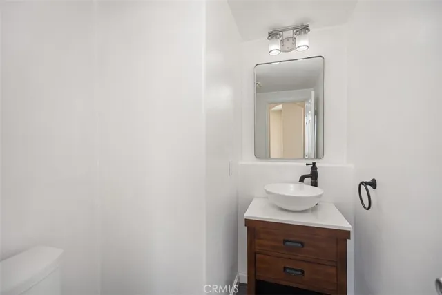 a bathroom with a sink vanity and mirror