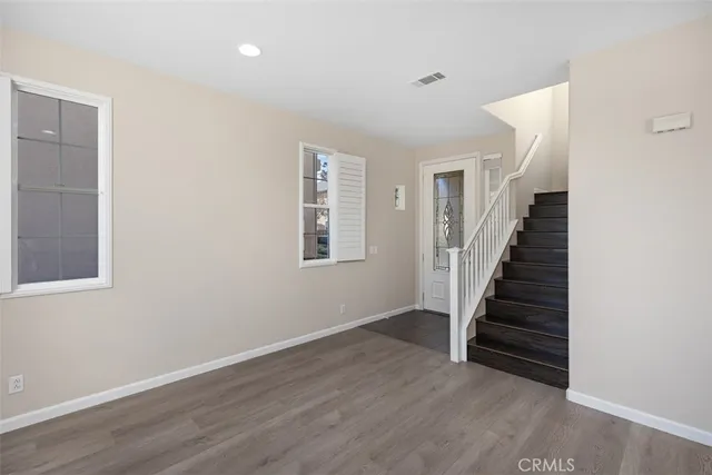 a view of entryway with stairs and wooden floor