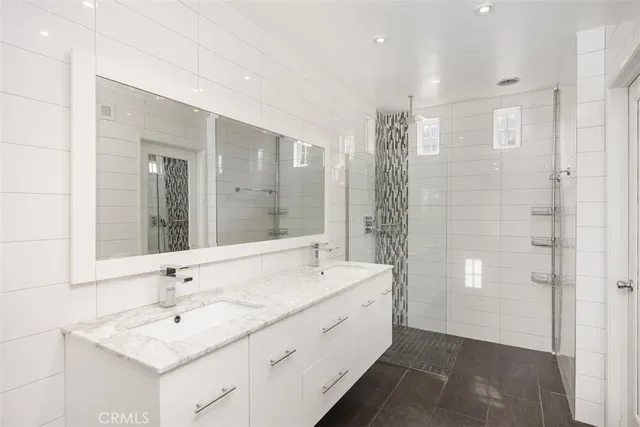 a bathroom with a double vanity sink and a mirror