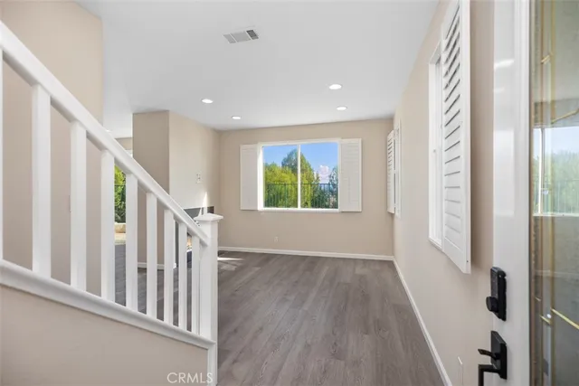 a view of an entryway with wooden floor