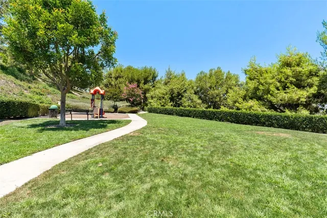 a view of a house with swimming pool and sitting area
