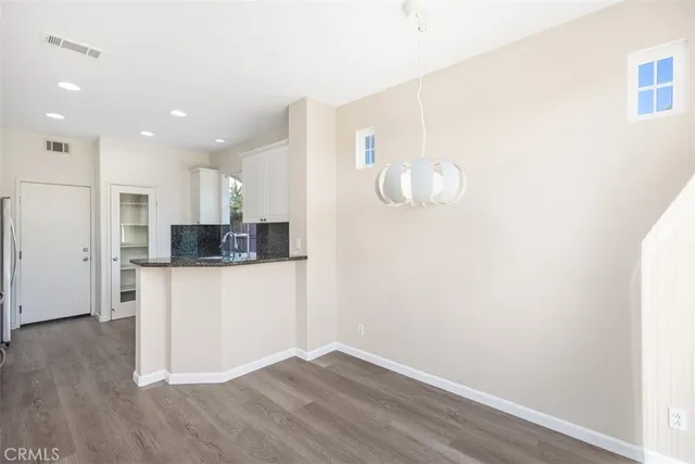 a kitchen with a refrigerator and microwave