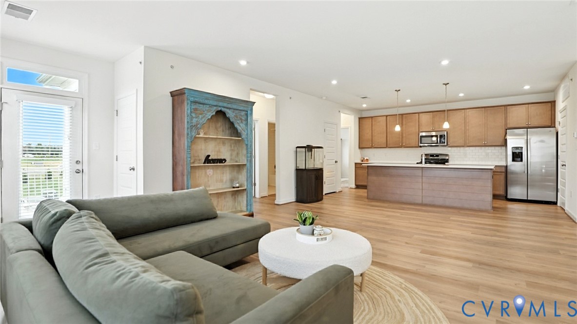 12109 Oxford Landing Drive, Unit 201 Glen Allen, VA 23059 - Photo 11 of 26 a living room with furniture and a large window