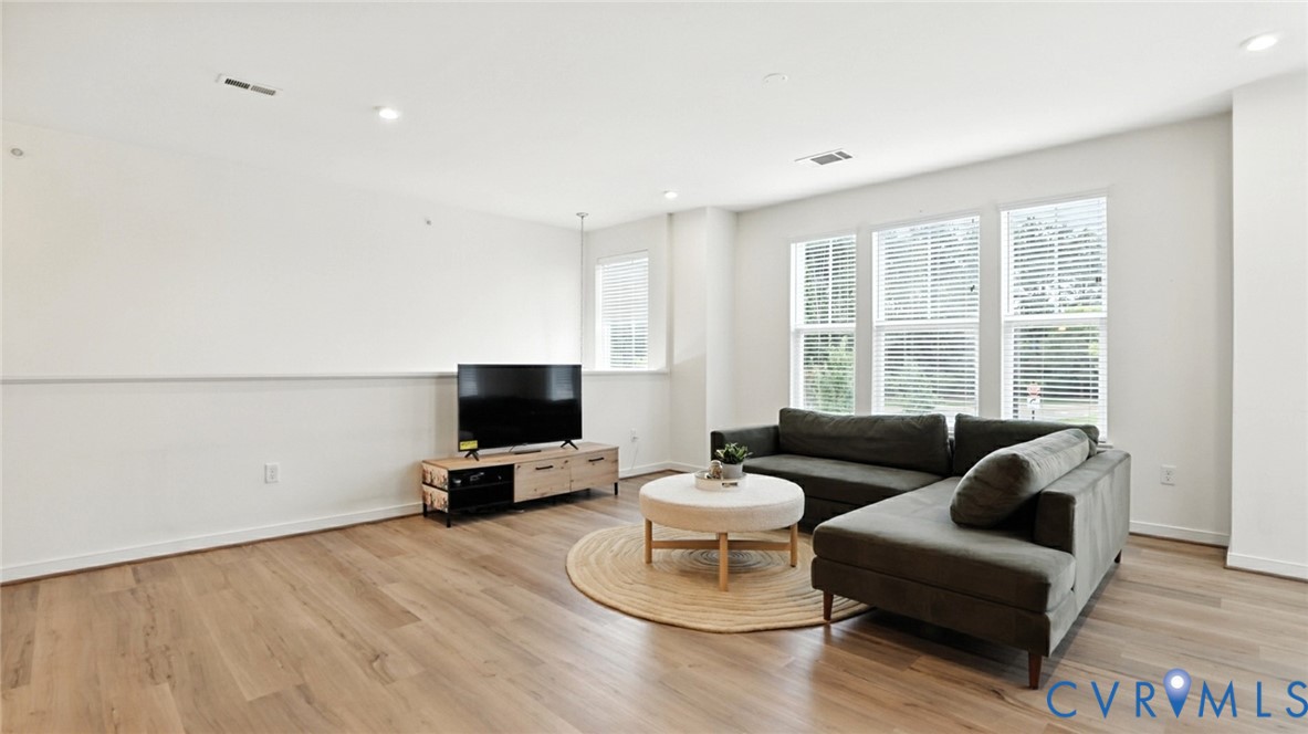 12109 Oxford Landing Drive, Unit 201 Glen Allen, VA 23059 - Photo 13 of 26 a living room with furniture and a flat screen tv