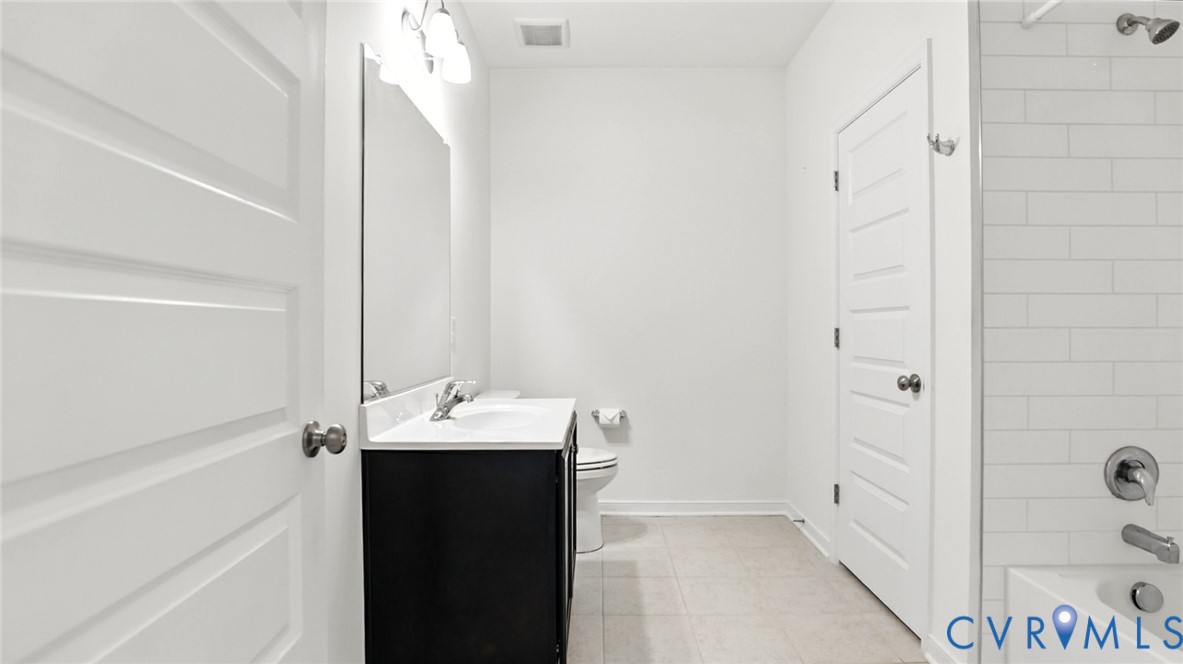 12109 Oxford Landing Drive, Unit 201 Glen Allen, VA 23059 - Photo 15 of 26 a bathroom with a sink and a mirror