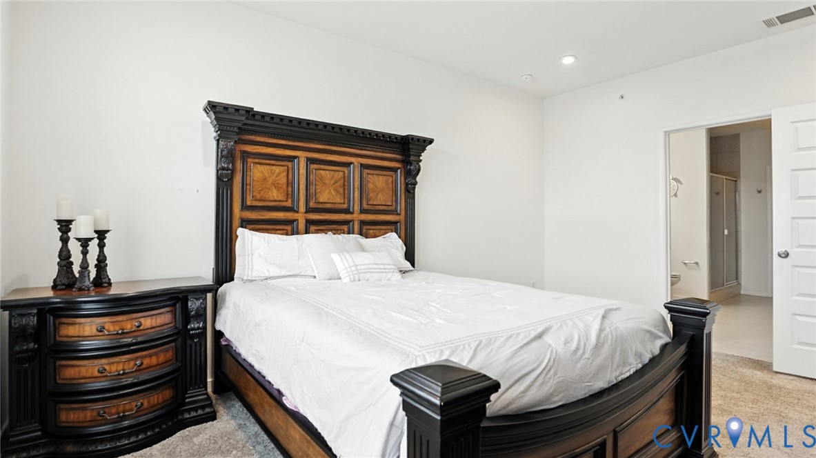 12109 Oxford Landing Drive, Unit 201 Glen Allen, VA 23059 - Photo 19 of 26 a bedroom with a bed and a dresser