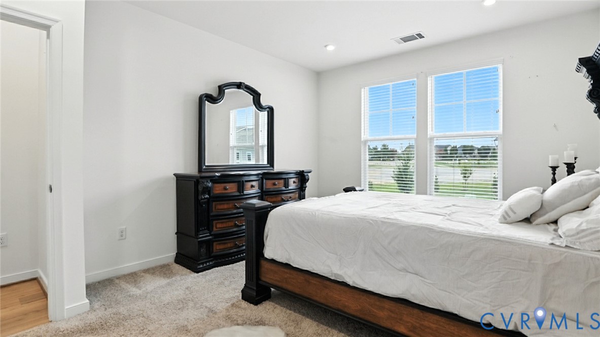 12109 Oxford Landing Drive, Unit 201 Glen Allen, VA 23059 - Photo 20 of 26 a bedroom with a bed and a dresser