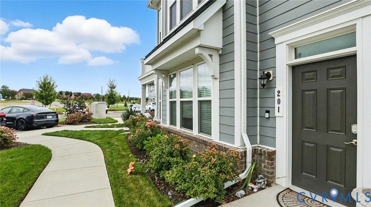 12109 Oxford Landing Drive, Unit 201 Glen Allen, VA 23059 - Photo 4 of 26 a view of a house with a yard