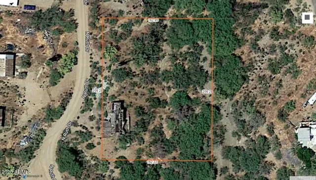 an aerial view of residential house with outdoor space and trees all around