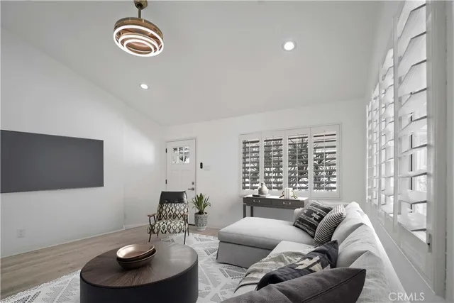 a living room with furniture a fireplace and a large window