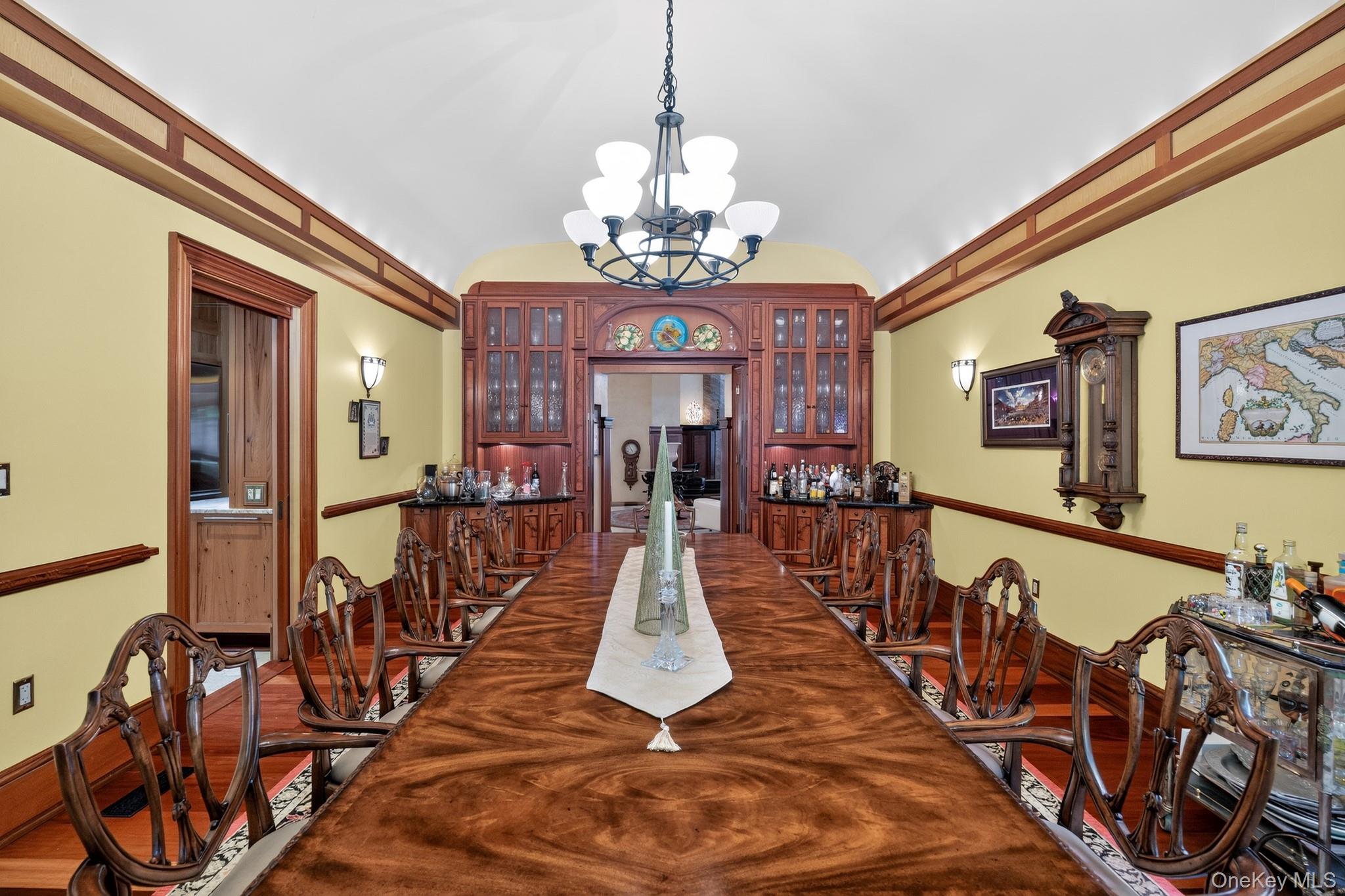 23 Inningwood Road Ossining, NY 10562 - Photo 18 of 50 Formal dining room featuring wood-finish flooring, an ornate chandelier, and custom built-in cabinetry with glass doors