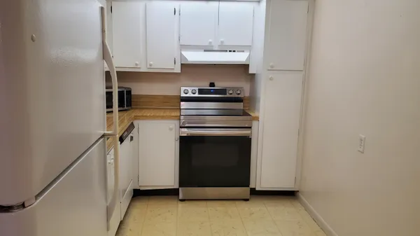 a kitchen with a stove and a refrigerator
