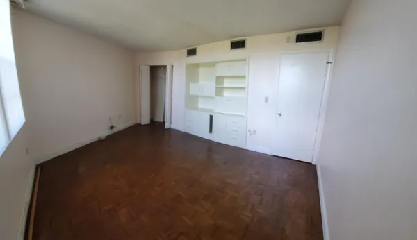 a view of empty room with white walls
