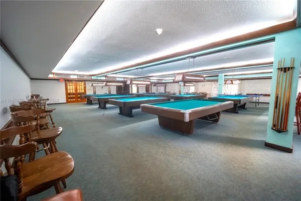 a room with gym equipment and large windows