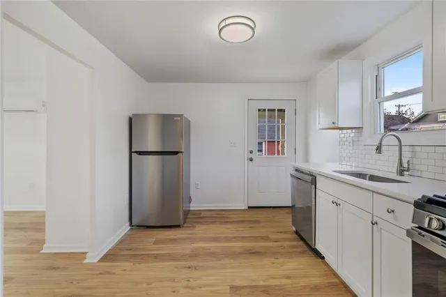 a kitchen with a sink and a refrigerator