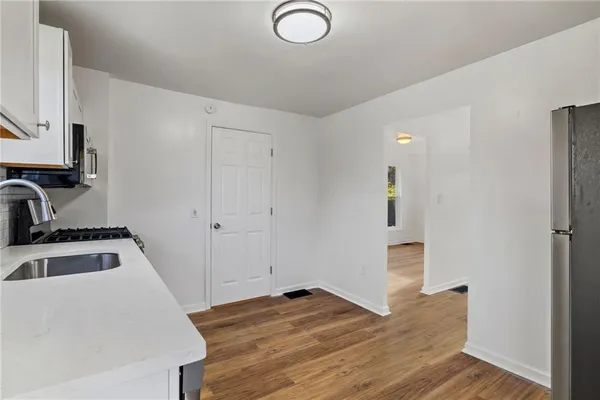 a kitchen with sink and refrigerator