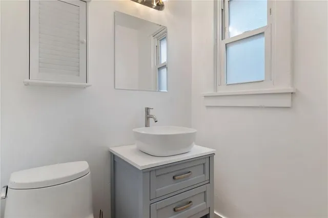 a bathroom with a sink toilet and mirror
