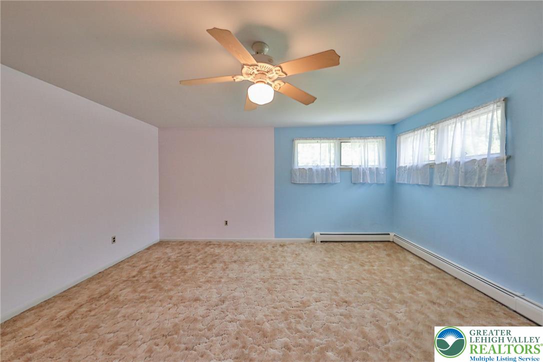 331 Cranberry Creek Road Cresco, PA 18326 - Photo 53 of 95 A comfortable bedroom with ample light, featuring a ceiling fan for climate control.