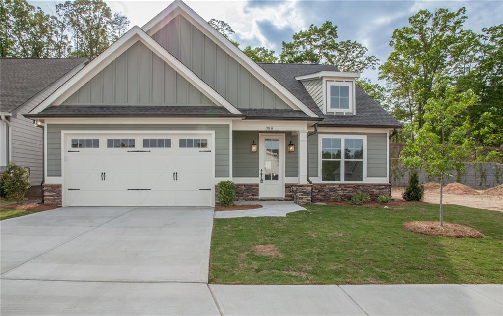 a front view of a house with a yard and outdoor seating