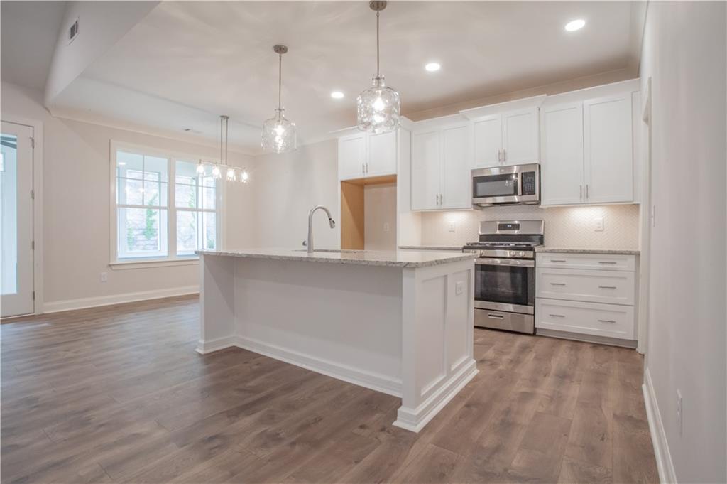 388 Maple View Drive Carrollton, GA 30117 - Photo 4 of 18 a kitchen with stainless steel appliances a refrigerator sink and microwave