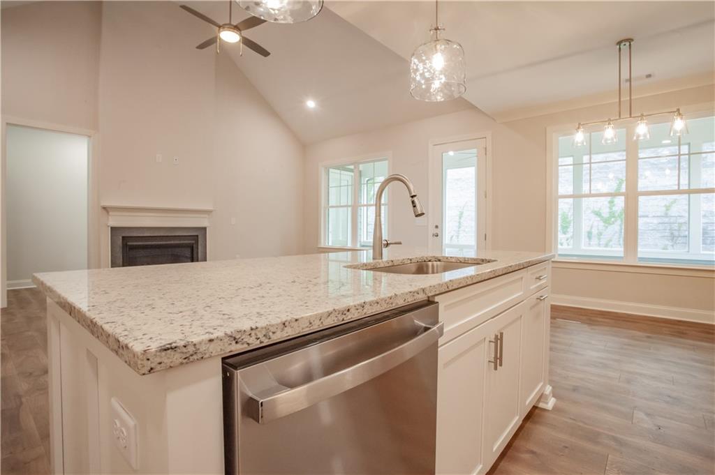 388 Maple View Drive Carrollton, GA 30117 - Photo 5 of 18 a kitchen with granite countertop cabinets a sink and dishwasher