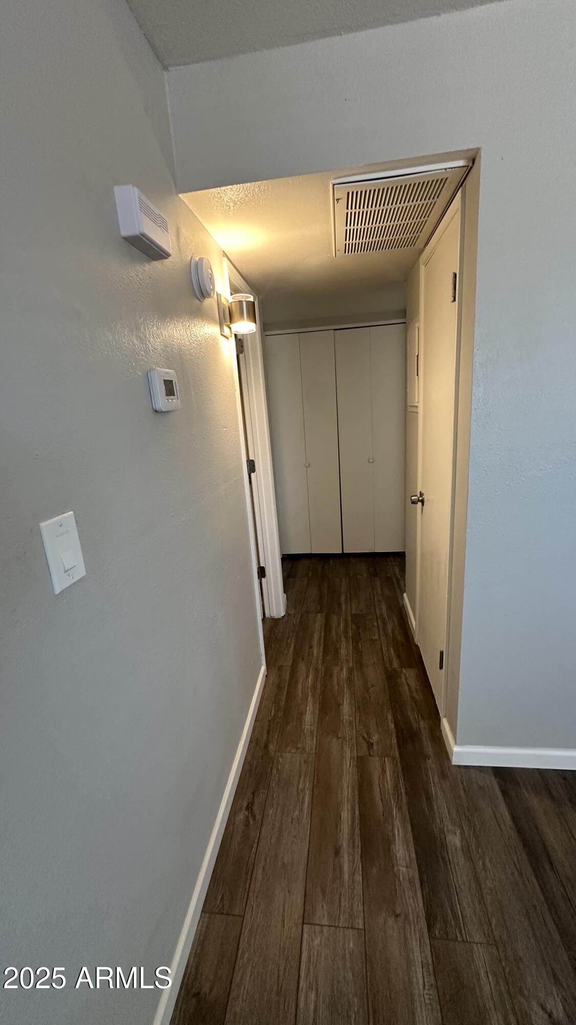 17847 North 40th Street, Unit 1 Phoenix, AZ 85032 - Photo 5 of 12 a view of a hallway with wooden floor